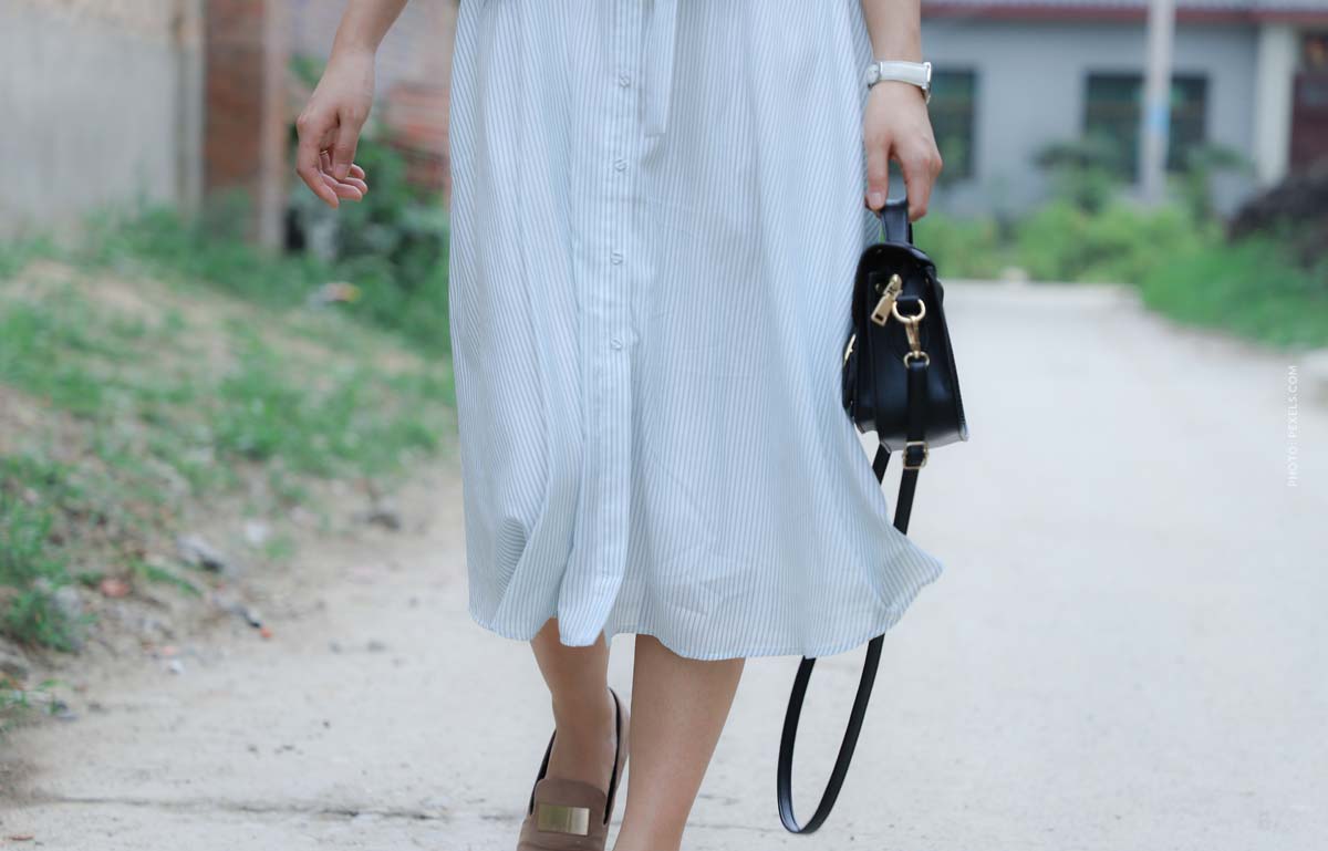 fashion-brand-coach-videos-woman-long-white-dress-with-black-handbag